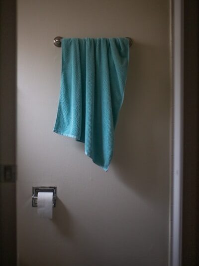 green towel on white wall